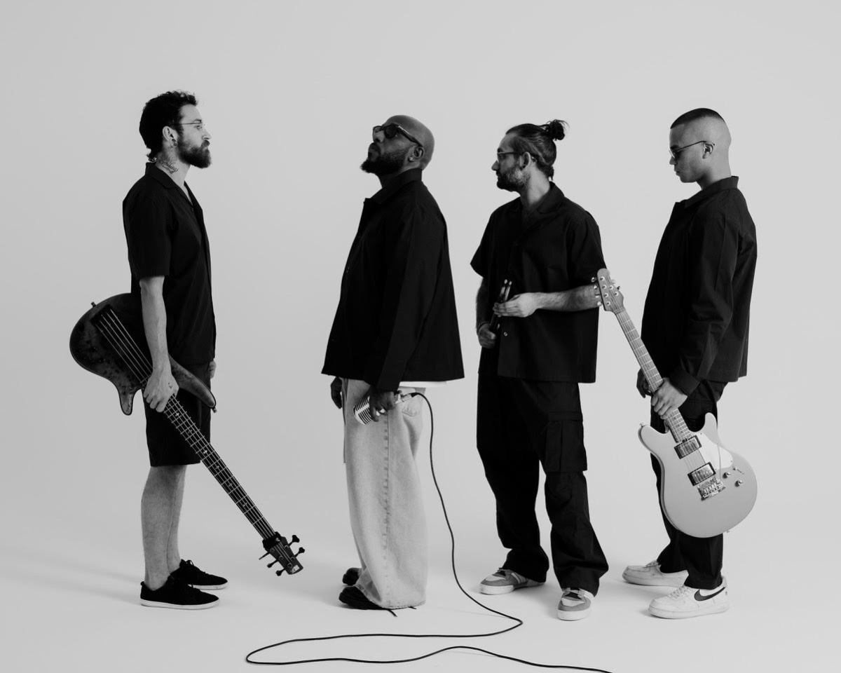 The band in the studio against a white backdrop