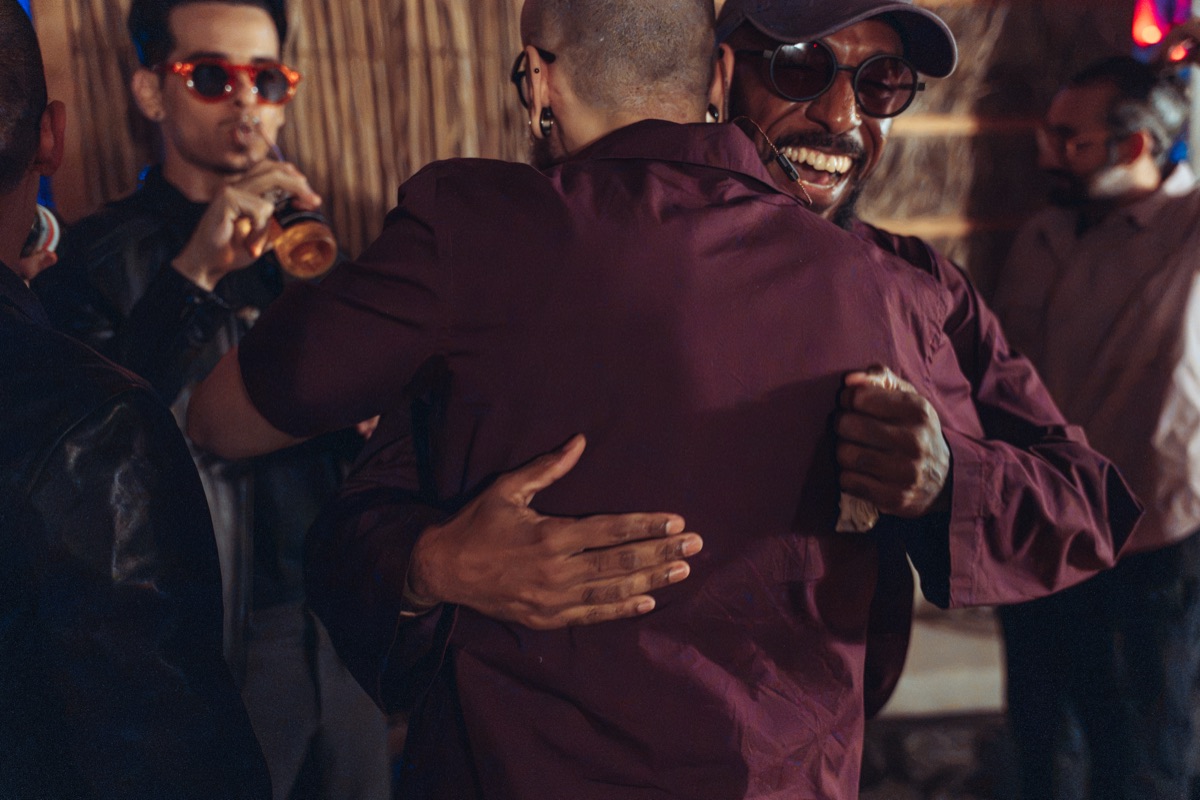 Two of the band hugging and laughing before the set