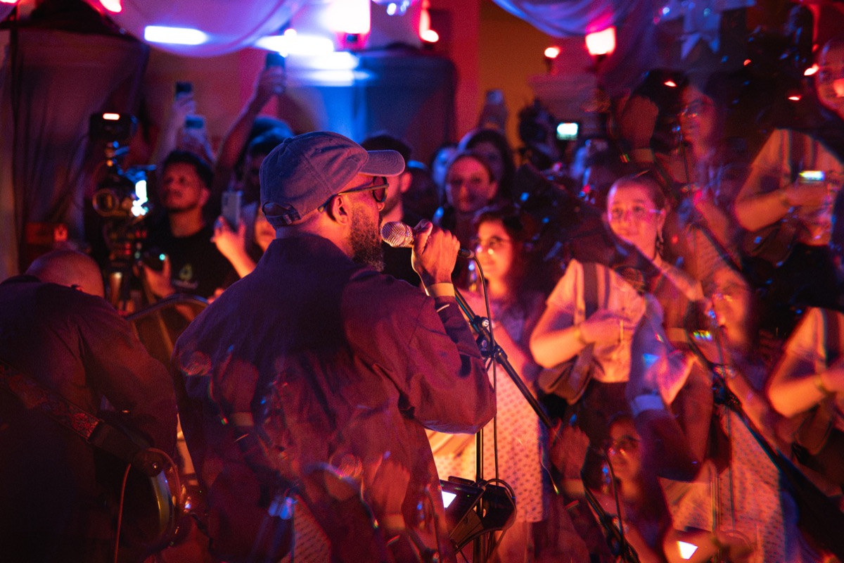 The singer at the mic, phones held up across the front row