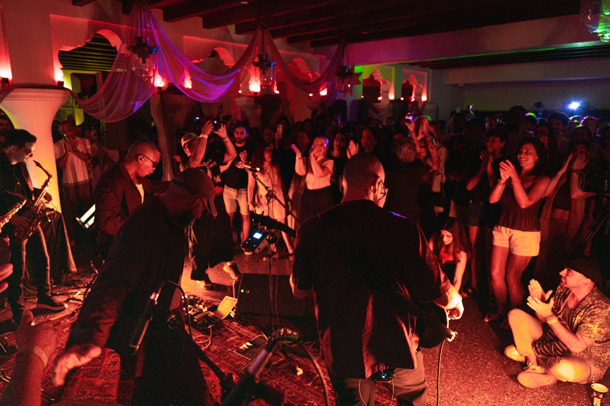 The band playing on the floor with the crowd on every side