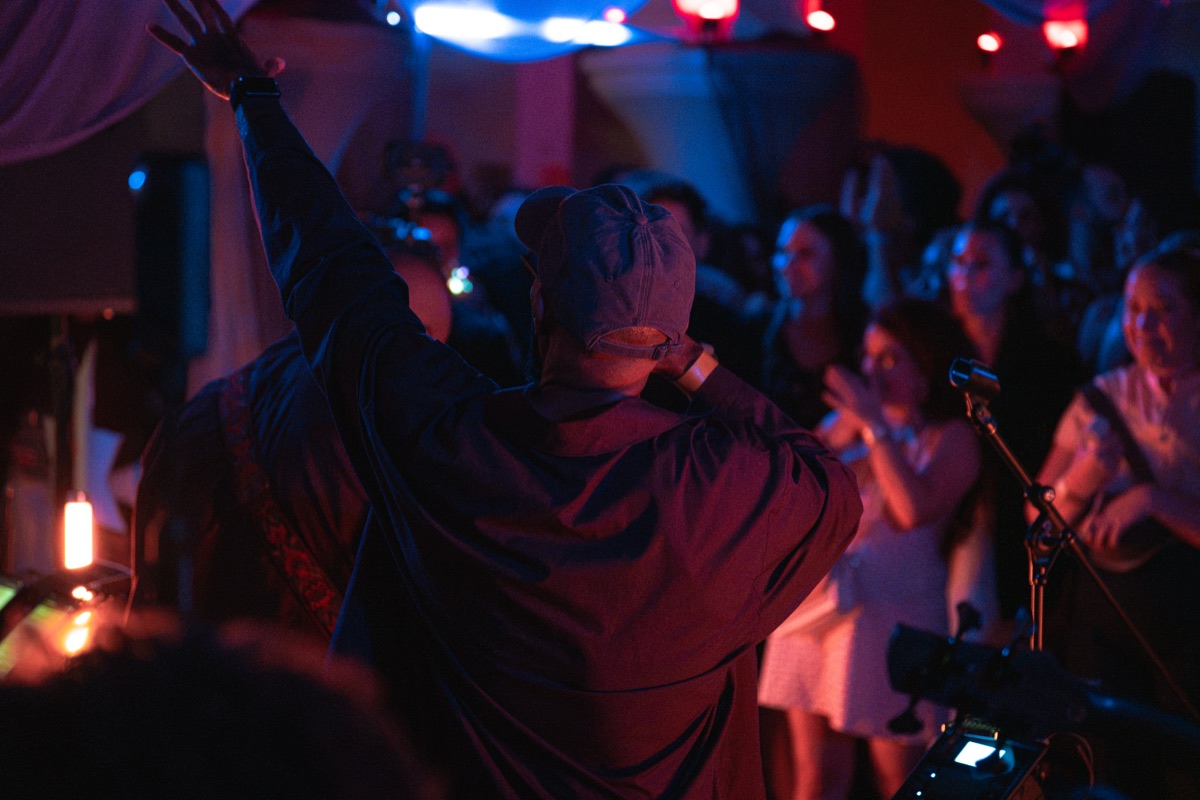 The singer with both arms raised to the crowd