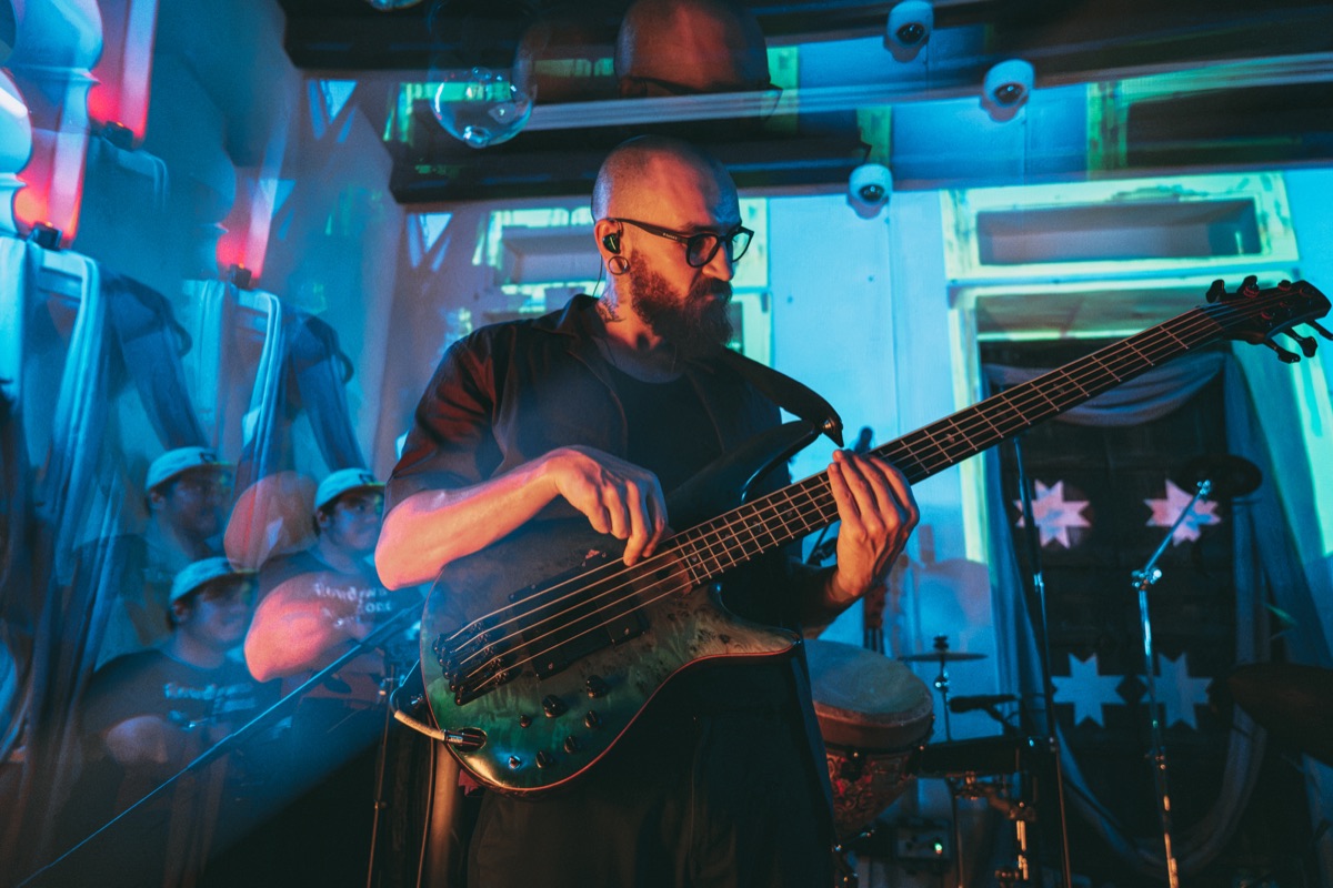A bass solo lit blue and green