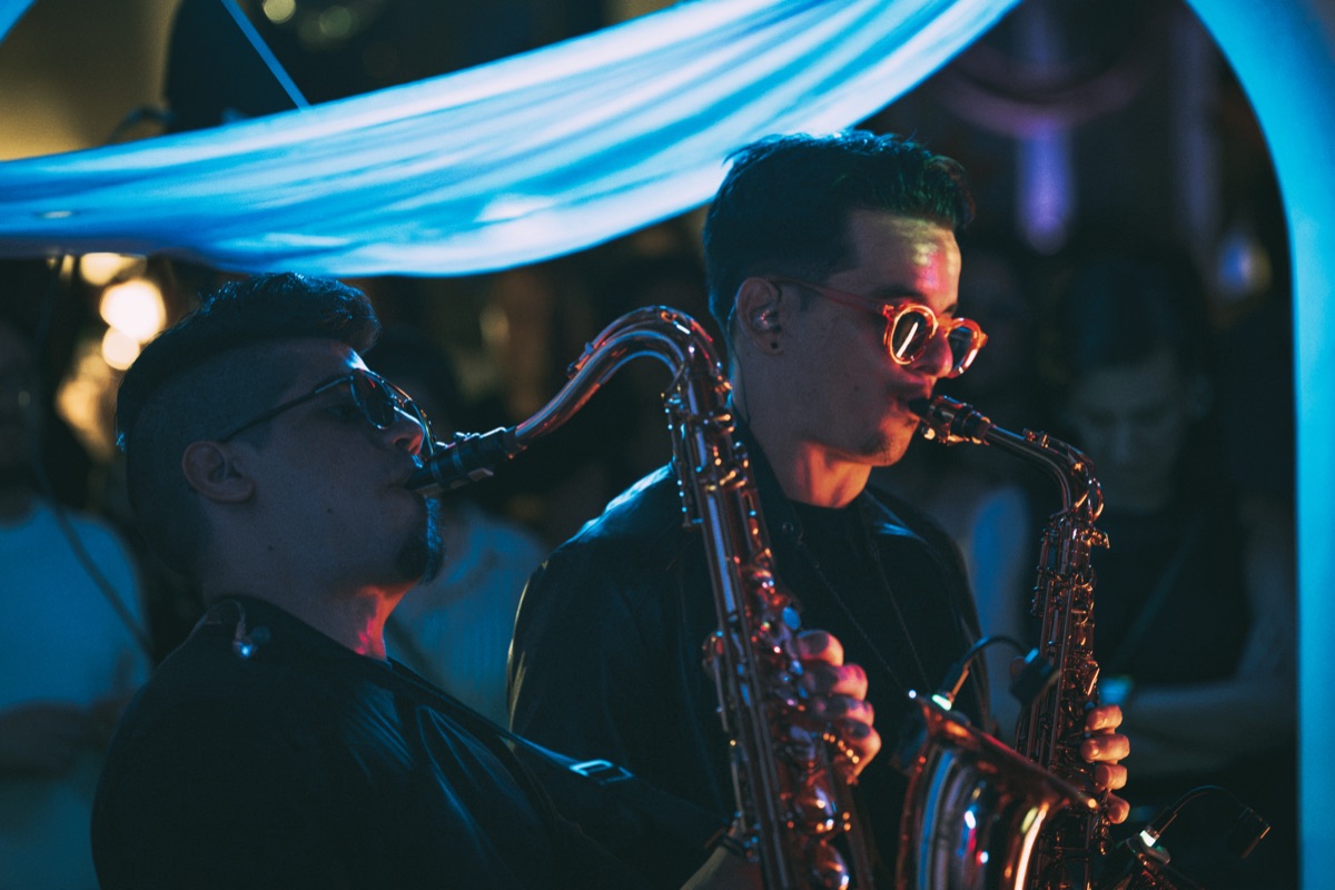 Two saxophones playing side by side