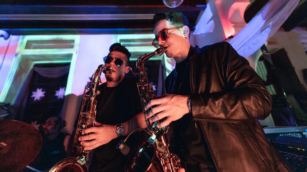 Two sax players leaning into a solo