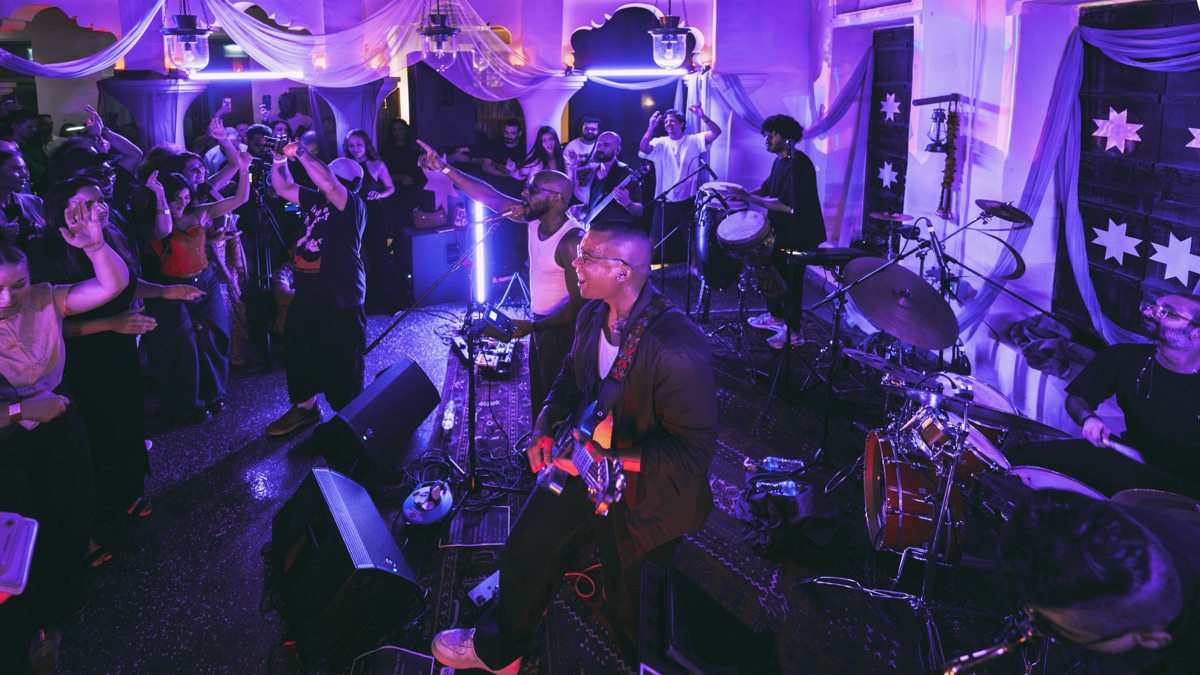 The room from the back, lit purple, band at the far end